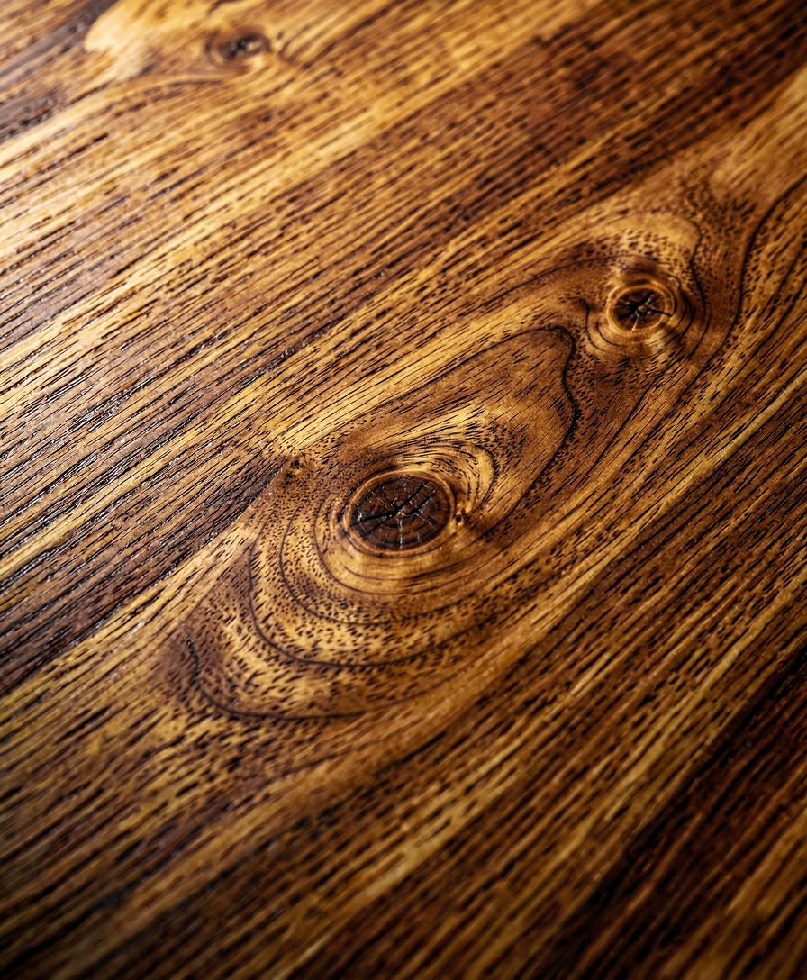 A wide-plank European oak board photographed in raking golden light